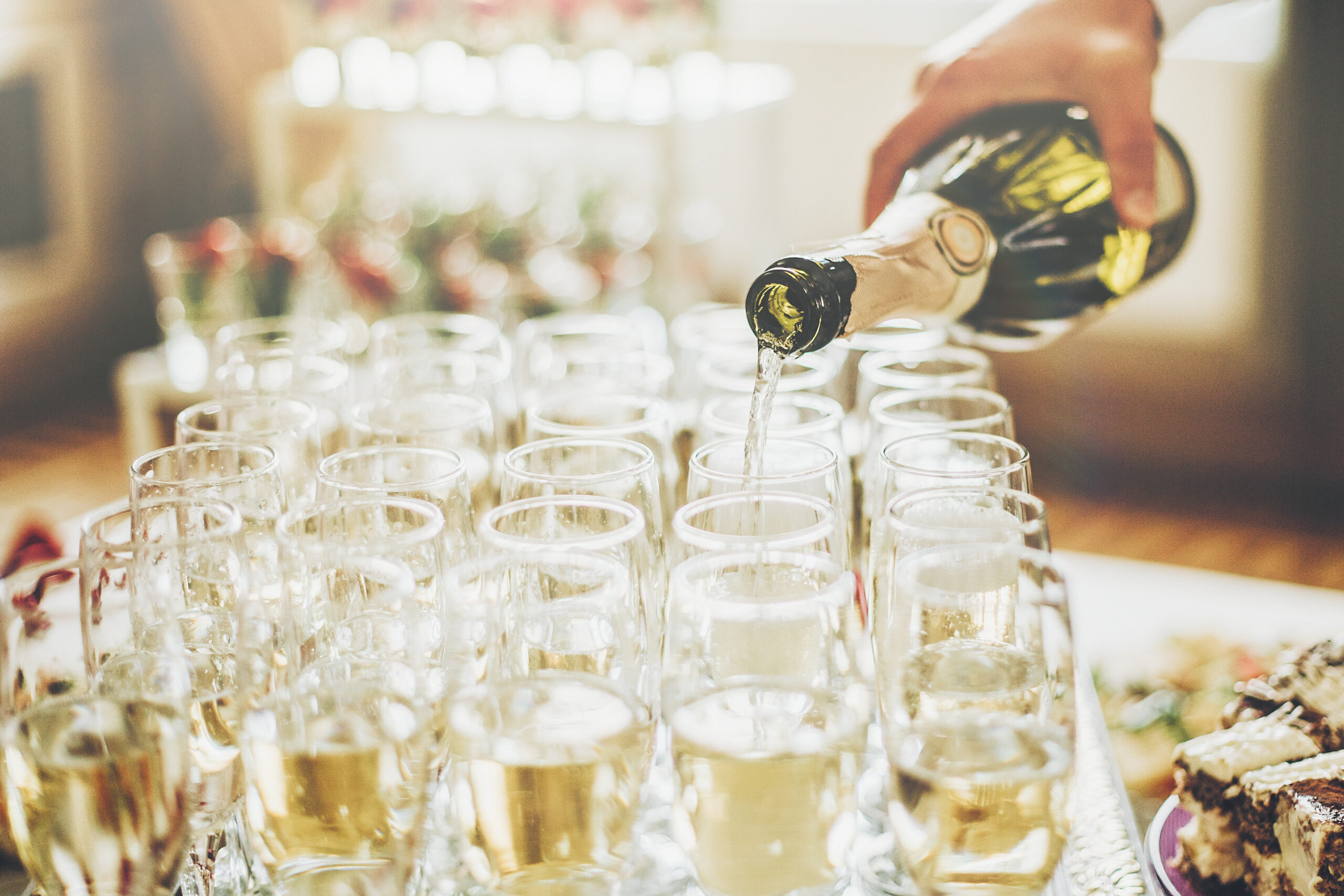 Waiter Pouring Champagne In Stylish Glasses At Luxury Wedding Re